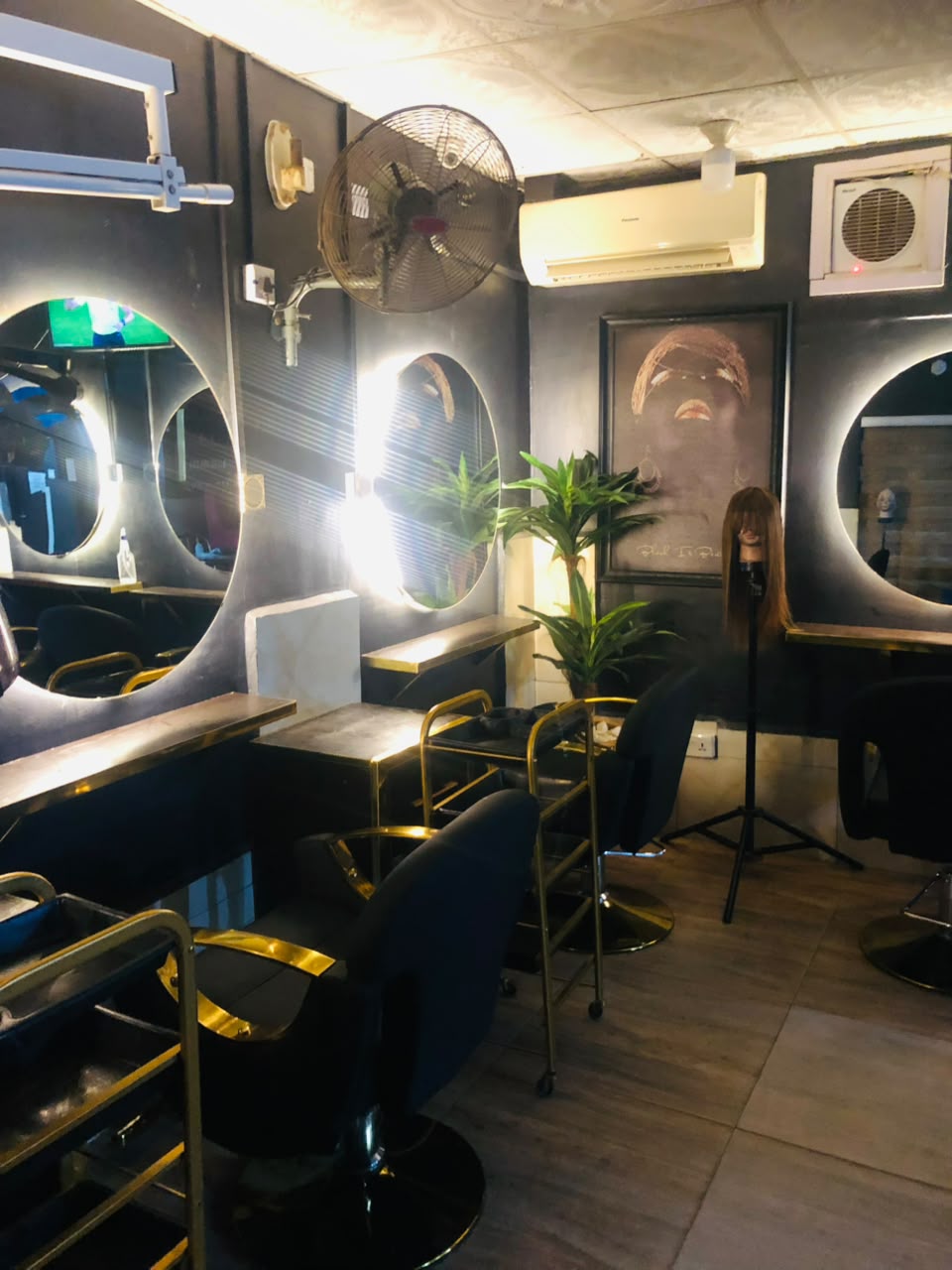 TripleD salon styling area with gold-accented chairs